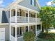 Charming two-story home with a double porch, perfect for relaxing outdoors at 1617 Heritage Garden St, Wake Forest, NC 27587