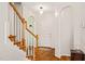 Bright foyer with hardwood floors and staircase with wooden railing and white spindles at 1617 Heritage Garden St, Wake Forest, NC 27587