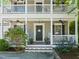 Charming home featuring a welcoming porch with rocking chairs and stylish landscaping at 1617 Heritage Garden St, Wake Forest, NC 27587