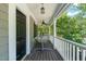 Inviting front porch with classic white railing and ceiling fan, a perfect place to relax at 1617 Heritage Garden St, Wake Forest, NC 27587