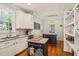 Well-equipped kitchen with white cabinets, granite countertops, and hardwood floors at 1617 Heritage Garden St, Wake Forest, NC 27587