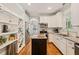 Well-lit kitchen with white cabinets, granite countertops, and an island at 1617 Heritage Garden St, Wake Forest, NC 27587