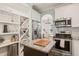 Well-equipped kitchen with stainless steel appliances, granite countertops, and custom wine storage at 1617 Heritage Garden St, Wake Forest, NC 27587