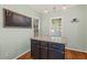 Kitchen island with granite countertops, hardwood floors and hanging pendant lights at 1617 Heritage Garden St, Wake Forest, NC 27587