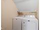 Convenient laundry area equipped with a washer and dryer for easy chore completion at 1617 Heritage Garden St, Wake Forest, NC 27587
