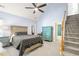 Main bedroom with high vaulted ceilings, carpeted floor, and staircase to second floor at 1617 Heritage Garden St, Wake Forest, NC 27587