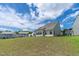 Hills slope gently in the backyard of this home on a beautiful, partly cloudy day at 1745 Ripley Woods St, Wake Forest, NC 27587
