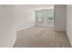 The carpeted bedroom boasts two windows letting in natural light and neutral paint at 1745 Ripley Woods St, Wake Forest, NC 27587