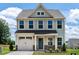Charming two-story home featuring a well-maintained front yard and a classic architectural design at 1745 Ripley Woods St, Wake Forest, NC 27587