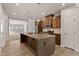Modern kitchen featuring stainless steel appliances and a large island with a sink at 1745 Ripley Woods St, Wake Forest, NC 27587