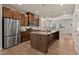 Bright, modern kitchen with stainless steel appliances, a large island, and ample cabinet space at 1745 Ripley Woods St, Wake Forest, NC 27587