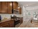 Modern kitchen features stainless steel appliances, granite countertops, and wood cabinets, perfect for cooking and entertaining at 1745 Ripley Woods St, Wake Forest, NC 27587