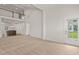 Bright living room with neutral carpet, high ceilings, and ample natural light, creating a welcoming and comfortable space at 1745 Ripley Woods St, Wake Forest, NC 27587