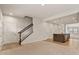 View of the living room showing staircase, and the kitchen with an island at 1745 Ripley Woods St, Wake Forest, NC 27587