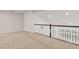Neutral carpeted loft area with natural light from windows and white doors at 1745 Ripley Woods St, Wake Forest, NC 27587