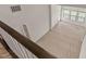 An aerial view of a neutral carpeted loft area with natural light from nearby windows at 1745 Ripley Woods St, Wake Forest, NC 27587