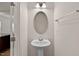 This powder room offers a pedestal sink, large oval mirror, towel bar, and light fixture at 1745 Ripley Woods St, Wake Forest, NC 27587