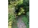 Picturesque backyard brick path surrounded by colorful flowers and lush greenery at 1800 Avondale Dr, Durham, NC 27701