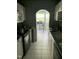 Kitchen features white cabinets and an archway leading to a dining area at 1800 Avondale Dr, Durham, NC 27701