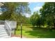 Spacious backyard with a view of a tranquil pond, seen from the deck with white railing at 1815 Chandellay Dr, Durham, NC 27705