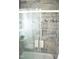 Updated bathroom with a tiled shower, glass door, and built-in niche at 1815 Chandellay Dr, Durham, NC 27705