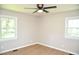 Light filled bedroom featuring two windows, wood floors, and neutral walls at 1815 Chandellay Dr, Durham, NC 27705