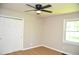 Comfortable bedroom with a ceiling fan and a large closet at 1815 Chandellay Dr, Durham, NC 27705