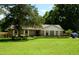 Well-maintained brick home with lush green lawn and mature shade trees in a peaceful setting at 1815 Chandellay Dr, Durham, NC 27705