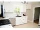 Bright kitchen featuring stainless steel appliances, white cabinets, and black hardware at 1815 Chandellay Dr, Durham, NC 27705