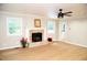 Spacious living room with hardwood floors, fireplace, ceiling fan, and great natural light at 1815 Chandellay Dr, Durham, NC 27705