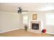 Spacious living room featuring an updated fan, decorative fireplace, mantel, and lots of natural light at 1815 Chandellay Dr, Durham, NC 27705