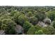 Aerial view of the home nestled in a lush, green, wooded neighborhood at 1815 Crystal Downs Lane, Raleigh, NC 27604