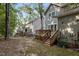 Back exteriors of the homes featuring decks with outdoor seating and lawns at 1815 Crystal Downs Lane, Raleigh, NC 27604