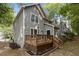 Back exterior of the home featuring a deck with outdoor seating and a lawn at 1815 Crystal Downs Lane, Raleigh, NC 27604