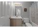 Neutral bathroom with updated vanity, mirror, lighting, and toilet with patterned shower curtain at 1815 Crystal Downs Lane, Raleigh, NC 27604