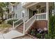 Inviting covered front porch with brick stairs and a view of the landscaped front yard at 1815 Crystal Downs Lane, Raleigh, NC 27604