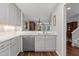 Open kitchen with stainless steel dishwasher and a view of dining and living areas at 1815 Crystal Downs Lane, Raleigh, NC 27604