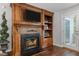 Cozy living room featuring a wooden fireplace and built-in shelves and cabinets at 1815 Crystal Downs Lane, Raleigh, NC 27604