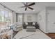 Bright living room features a comfortable sofa, stylish armchairs, a ceiling fan, and lots of natural light at 1815 Crystal Downs Lane, Raleigh, NC 27604