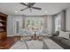 Cozy living room with hardwood floors, ceiling fan and lots of natural light coming through the windows at 1815 Crystal Downs Lane, Raleigh, NC 27604