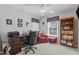 Inviting home office features a wooden desk, bookshelf, and a red reading chair with ottoman at 1815 Crystal Downs Lane, Raleigh, NC 27604