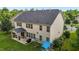 Back exterior view featuring a covered patio, lush lawn, and a play set at 184 Elgin Ct, Burlington, NC 27215