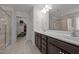 Bathroom with dual vanity, walk-in closet, and tiled shower at 184 Elgin Ct, Burlington, NC 27215