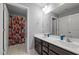 Bathroom featuring double sink vanity and shower with fun and colorful sports-themed curtain at 184 Elgin Ct, Burlington, NC 27215
