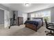 Bedroom with gray walls and carpet, a bed, dresser and office space at 184 Elgin Ct, Burlington, NC 27215