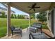 Relaxing covered patio with comfortable seating and a view of the landscaped backyard at 184 Elgin Ct, Burlington, NC 27215