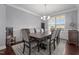 Dining room featuring a dark wood table with upholstered chairs, hardwood floors, and wainscoting at 184 Elgin Ct, Burlington, NC 27215