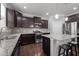 Modern kitchen with granite countertops, stainless steel appliances, and dark wood cabinets at 184 Elgin Ct, Burlington, NC 27215