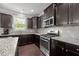 Well-appointed kitchen with stainless steel appliances, granite countertops, and dark cabinetry at 184 Elgin Ct, Burlington, NC 27215