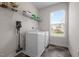 Functional laundry room with washer, dryer, and shelving at 184 Elgin Ct, Burlington, NC 27215